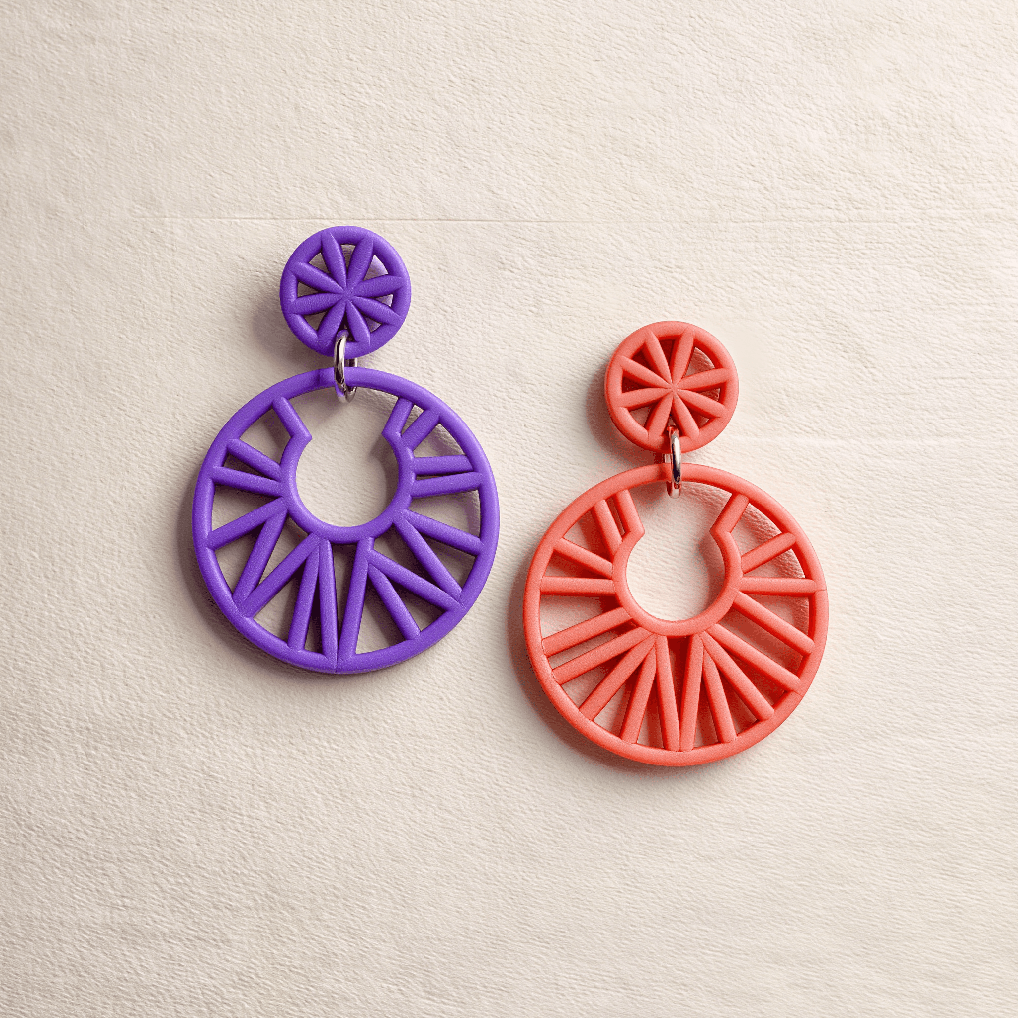 Lightweight 3D-printed statement earrings in violet and coral